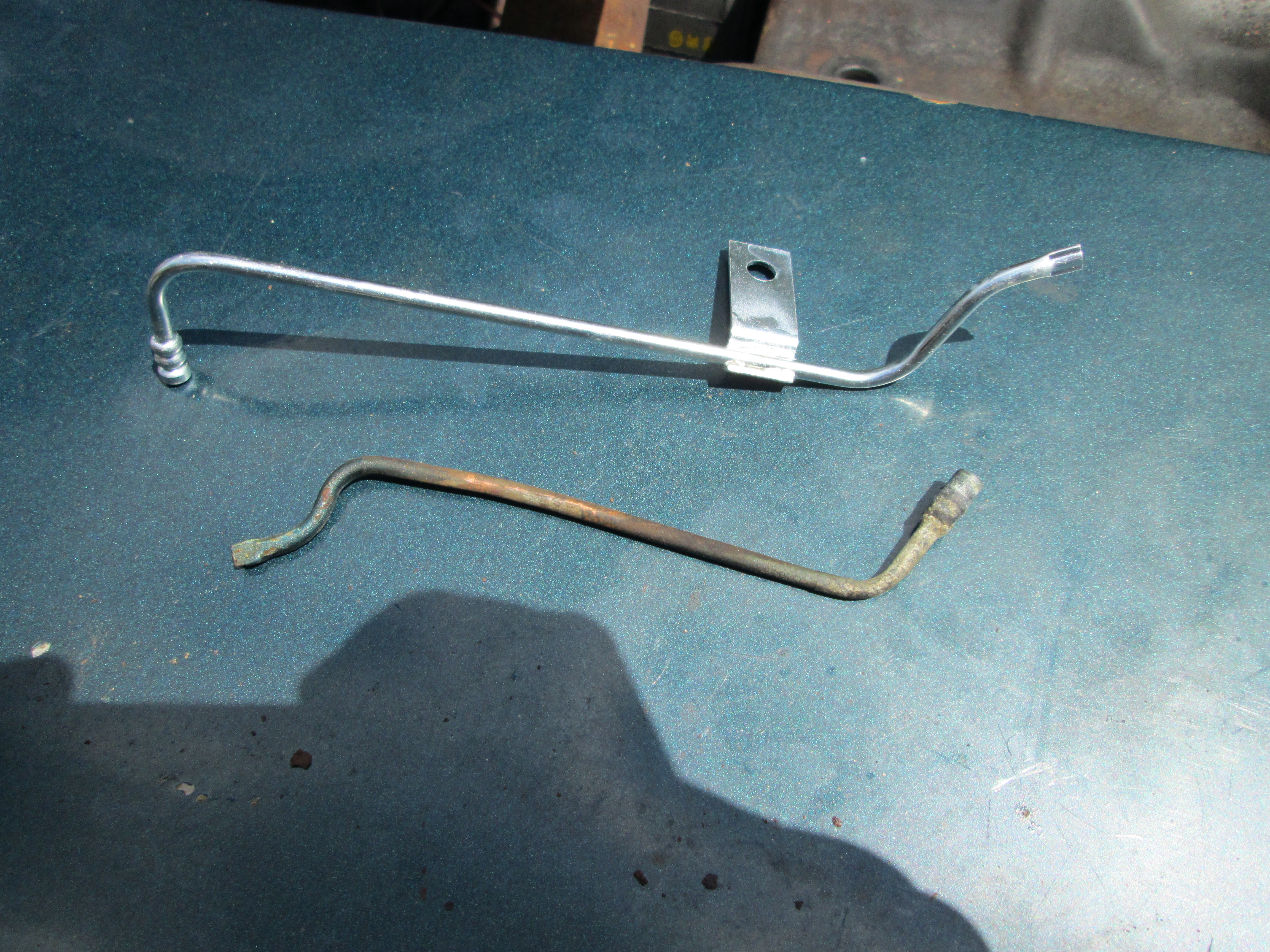 Old verses new. The new silver ones are actually designed for the '67 camaro, but still worked on the impala with minimun modifications. You can see that the old ones are missing their mounting bracket. It corroded off.